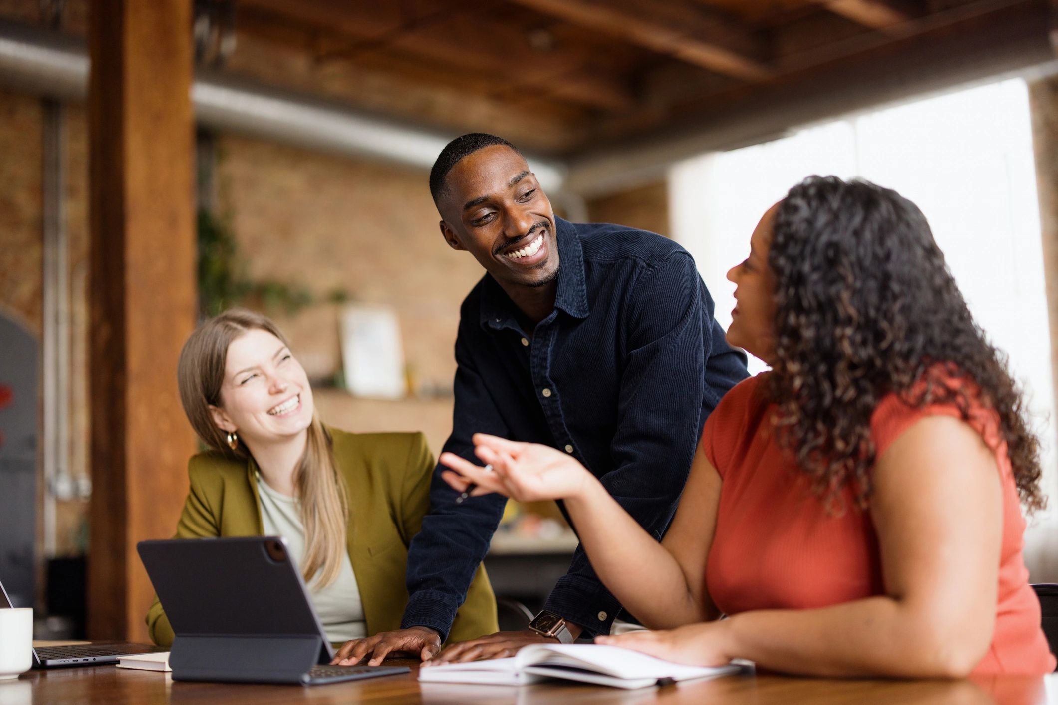 Colleagues discussing work in office